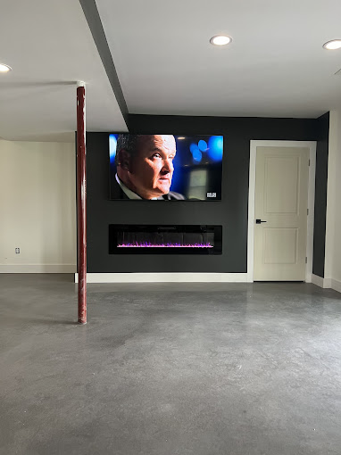 An empty room with a large screen on the wall