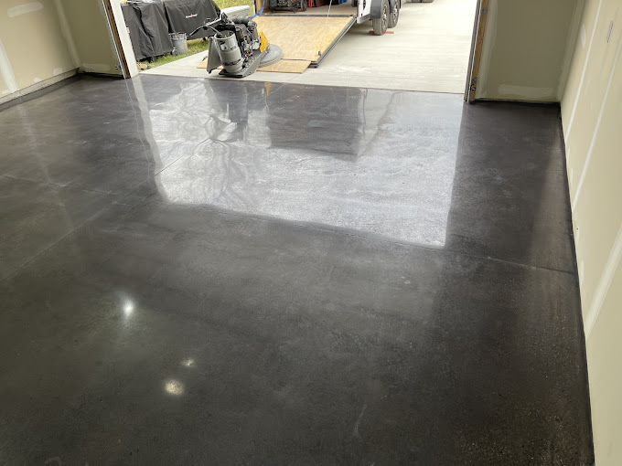 A garage floor with a motorcycle parked in it