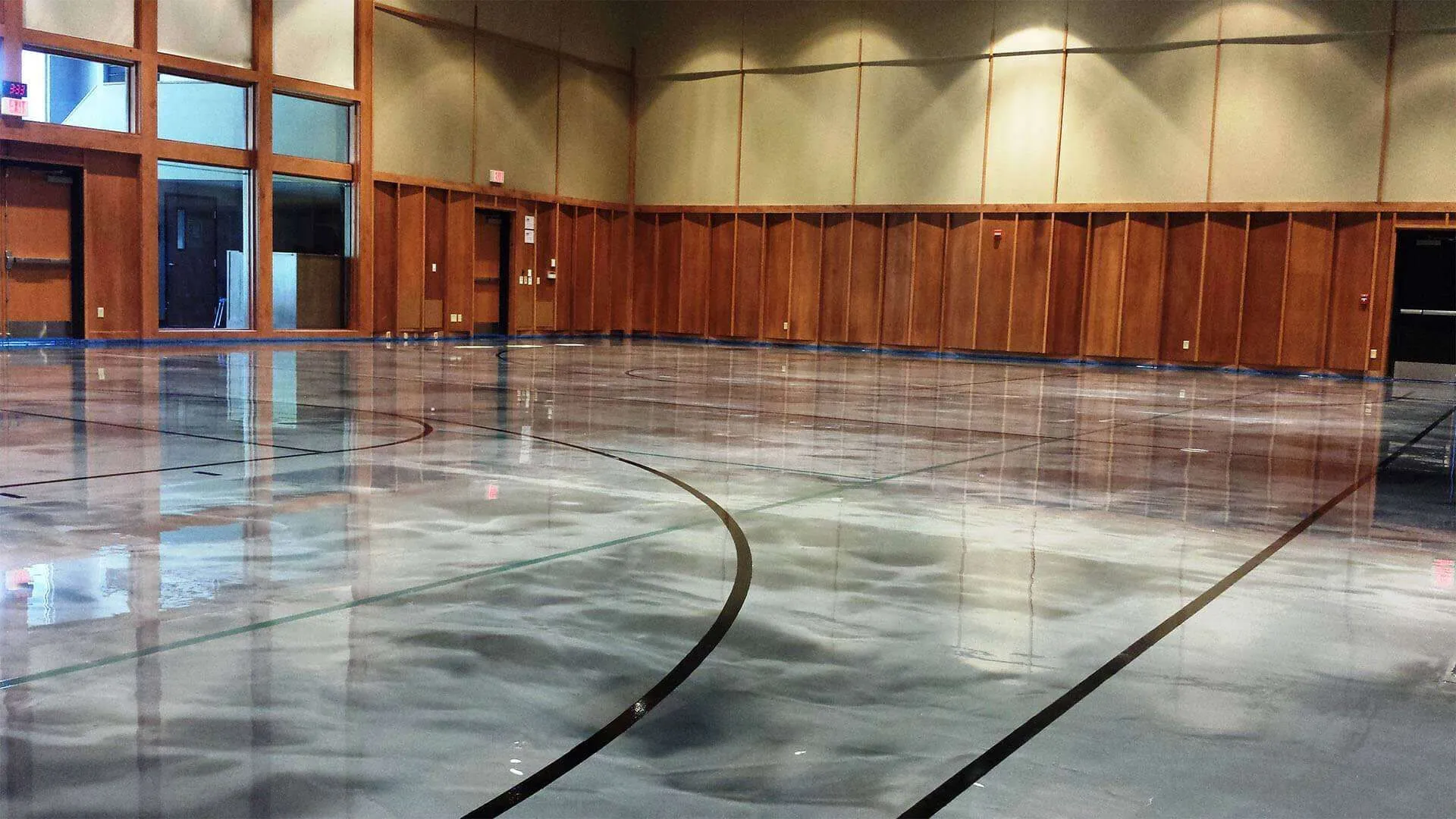 A large empty room with wood paneled walls