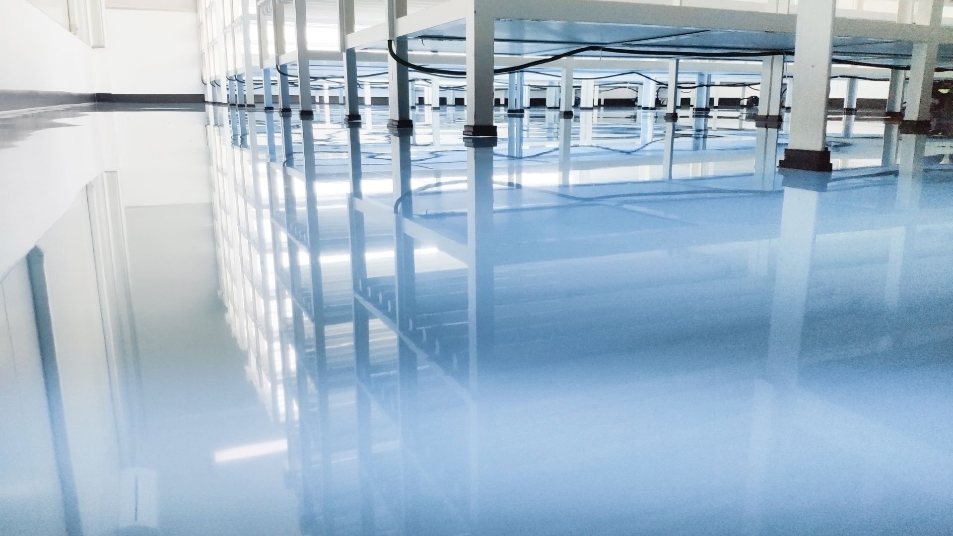 A large room with a blue floor and white walls